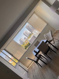 Manual light-filtering shades installed on residential windows
