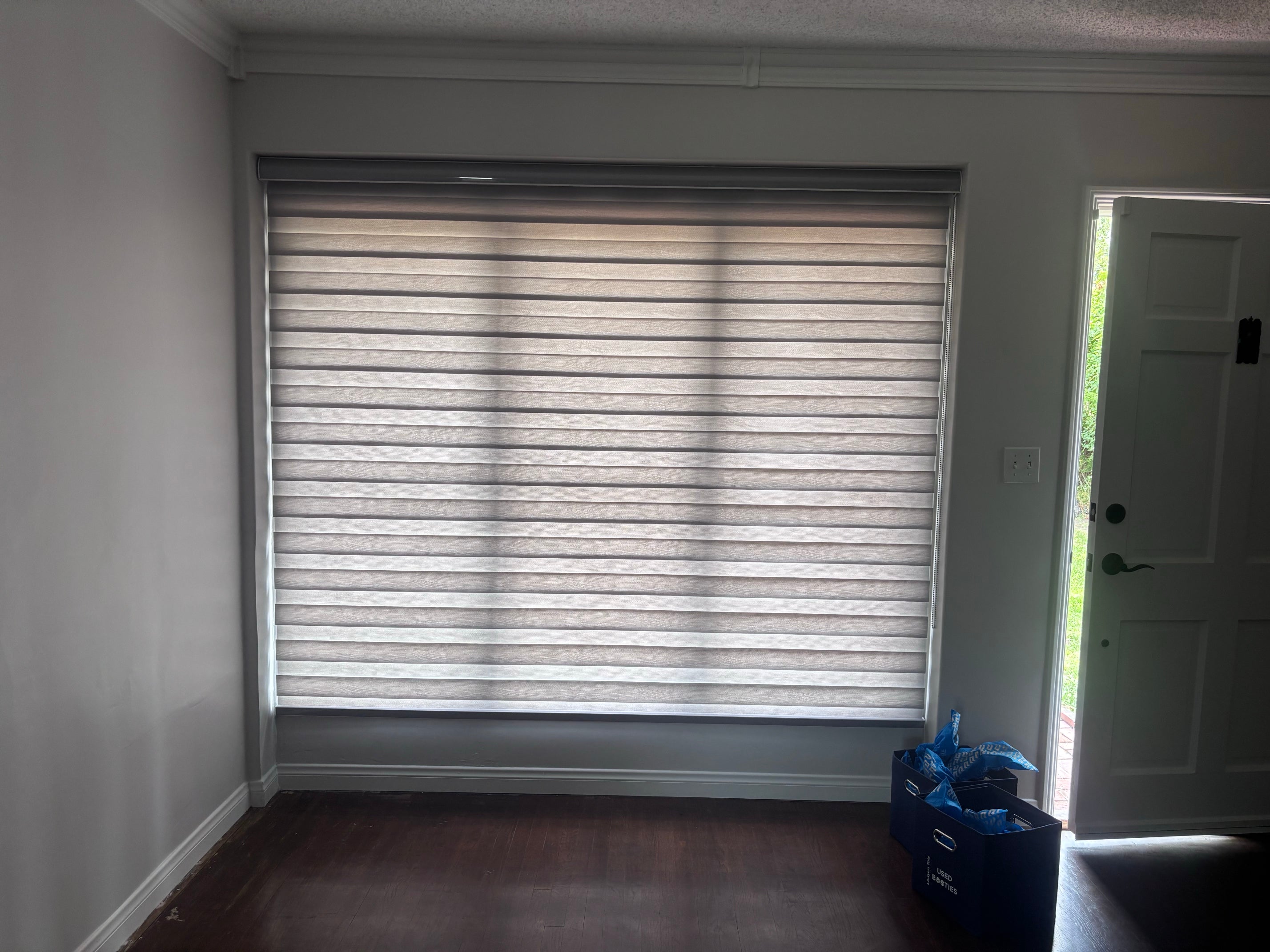 White zebra roller shades adjusted to filter sunlight while maintaining privacy.