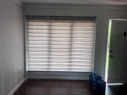 White zebra roller shades adjusted to filter sunlight while maintaining privacy.