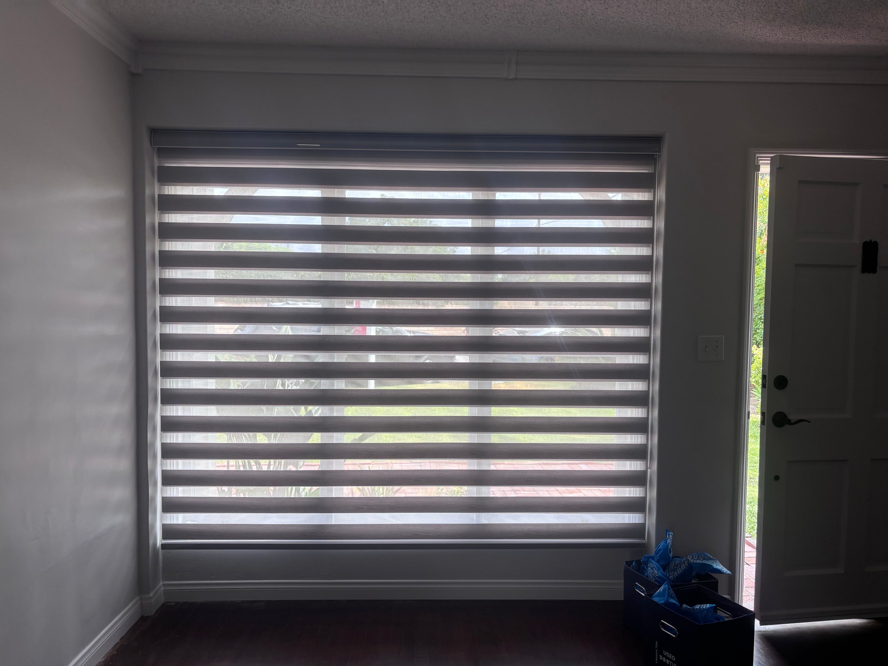 White custom zebra roller shades installed on a large window in Arcadia, California.