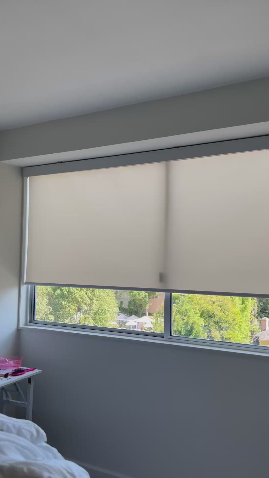 Motorized light-filtering roller shade opening to soften natural light